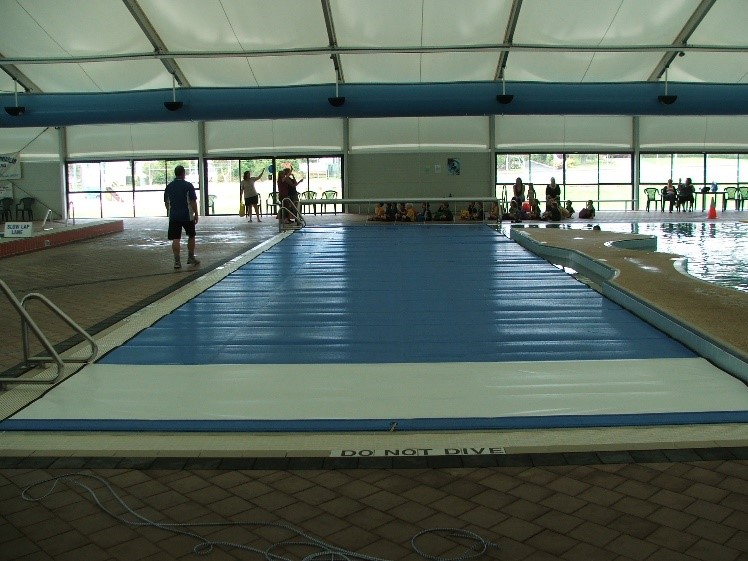 Lap pool at Aquacentre covered with blue pool blanket.