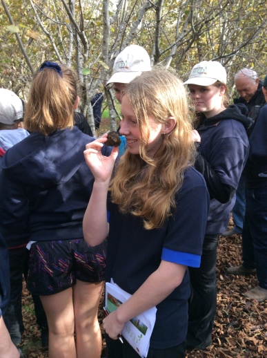 Students visiting truffle farm, smelling truffle