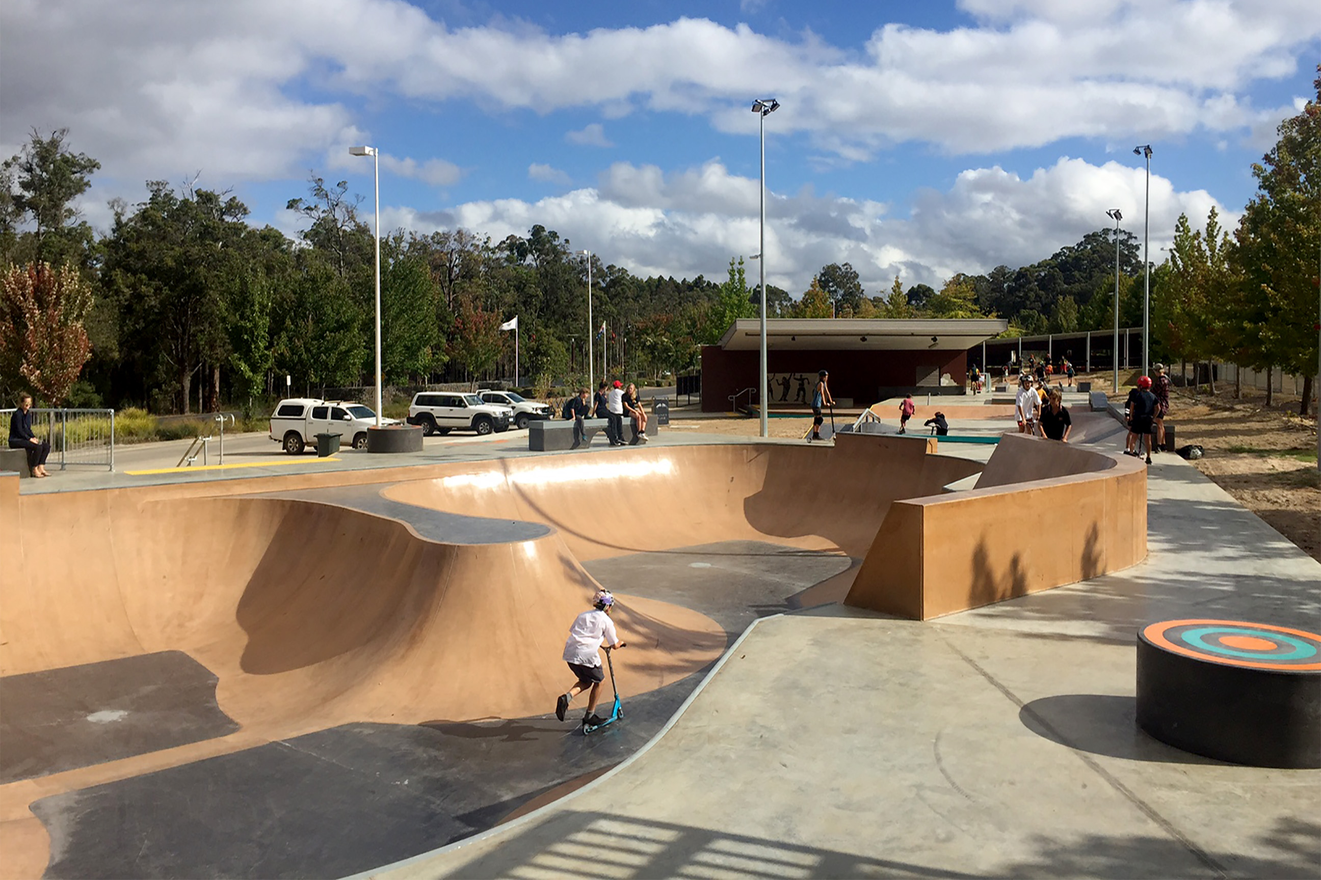 youth riding scooter at the manjin rec plaza